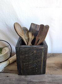 Handmade rustic wooden kitchen utensil holder with spoons and spatulas, crafted from reclaimed Wyoming wood