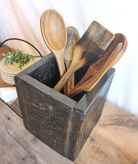 Handmade rustic wooden kitchen utensil holder with spoons and spatulas, crafted from reclaimed Wyoming wood