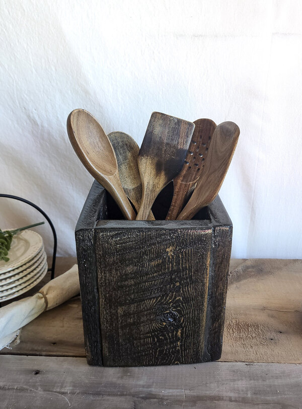 Handmade rustic wooden kitchen utensil holder with spoons and spatulas, crafted from reclaimed Wyoming wood